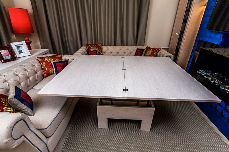 Acogedora sala de estar con mesa transformadora y alfombra suave.