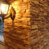 La lampe sur le mur dans le couloir, garnie de pierre