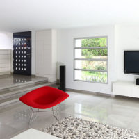 Fauteuil rouge dans un salon blanc