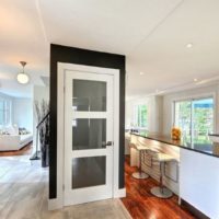 Encadrement noir autour d'une porte blanche